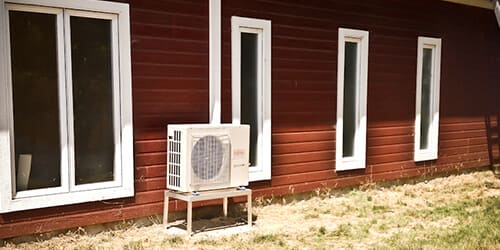 Outdoor unit of a compact central system installed along a residence